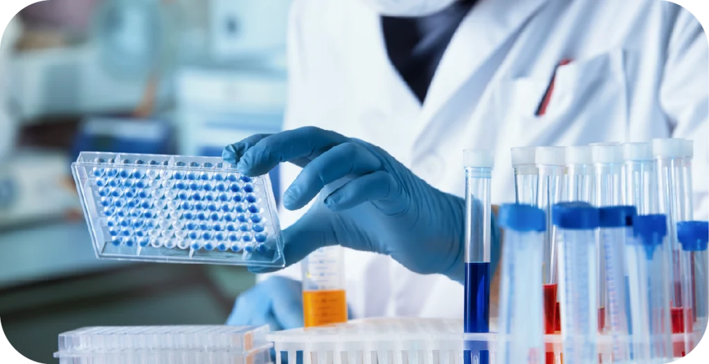 a scientist in a lab with equipment and reagents conducting STI PCR testing